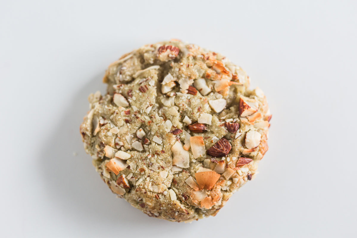 Pandan Almond cookie with a mix of coconut flakes and almonds on a white background.